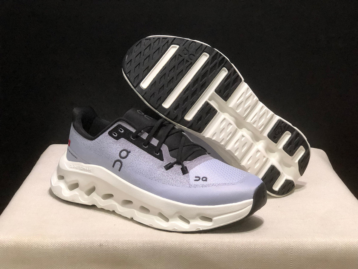On Cloudmonster running shoe in lavender and black, showing side profile and sole view